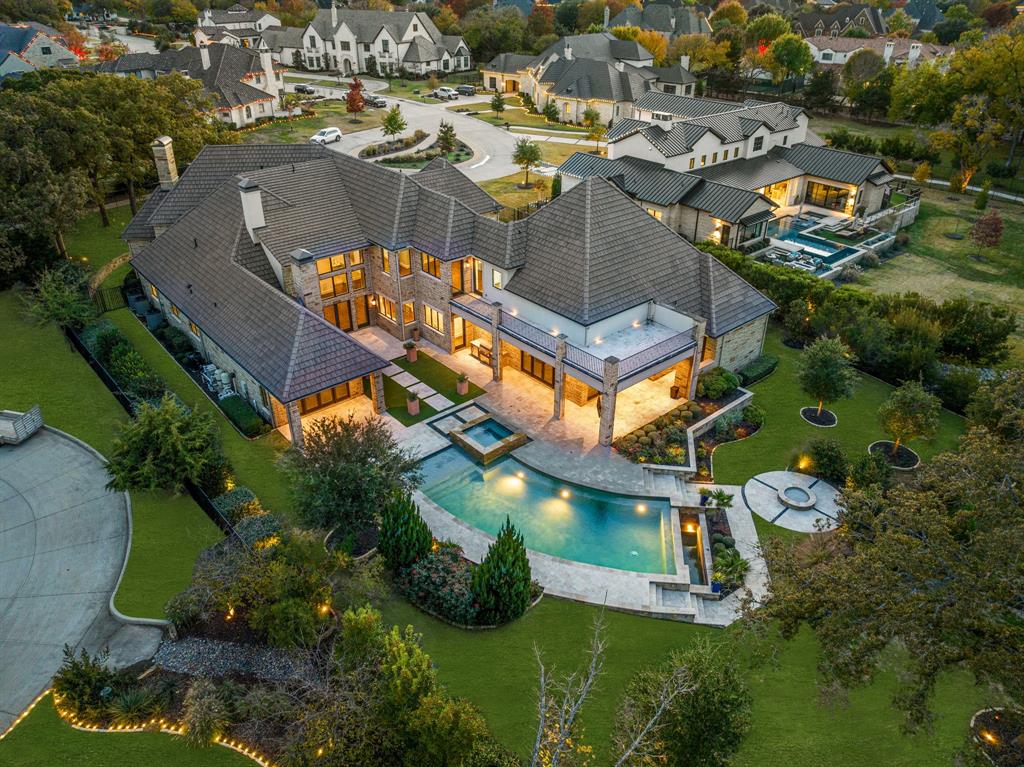 Experience the allure of this stunning Calais Custom home nestled on an expansive and RARE 1.5 acre lot adjacent to scenic walking trails in Westlake. Enter into grand foyer with captivating sweeping staircase with a glass encased wine cellar. Open floorplan effortlessly connects the dining area, living space, and a refined gourmet kitchen with soft close cabinetry, Wolf appliances, elegant marble island perfect for family gatherings with a convenient caterer's kitchen. The 1st floor game room, complete with a wet bar, extending to the outdoor oasis, creating an ideal space for entertaining. The private Master suite exudes opulence with a cozy fireplace, venetian plaster accents, his&hers oversized custom closets, secure safe room with direct access to the outdoor retreat. Discover expansive sitting areas and a stunning Watercrest pool and spa, lush landscaping, fire pit, creating an inviting outdoor haven. Zoned for Westlake Academy or Carroll ISD, this home is truly a gem!