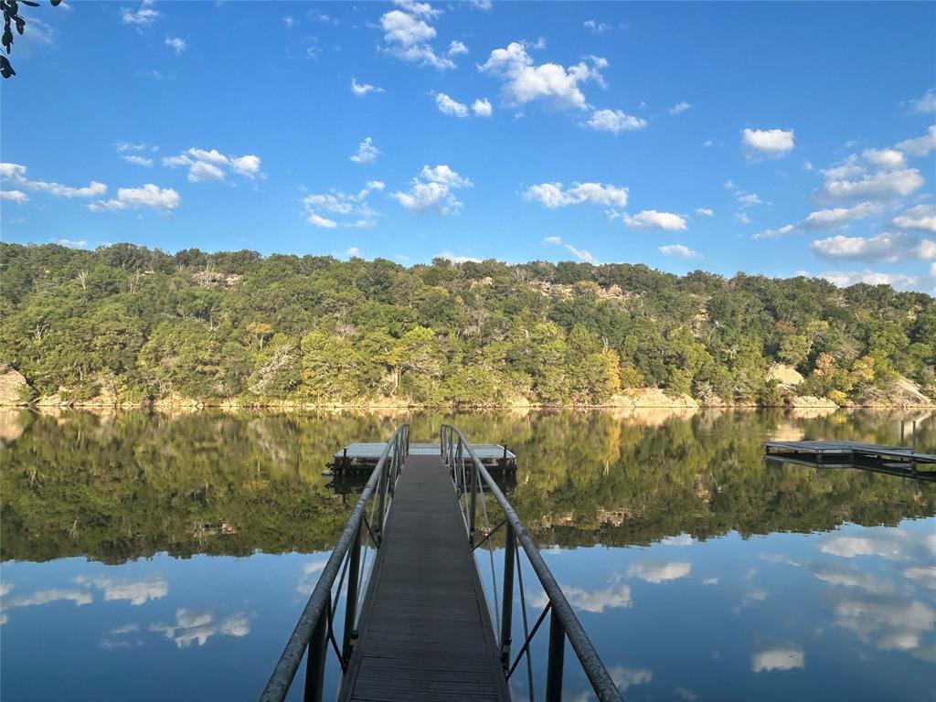 WATERFRONT! Dragonfly Cottage offers deeded waterfront on Rock Creek at Possum Kingdom Lake with no HOA and no known restrictions against short-term rentals, including Airbnb and VRBO. Conveniently located approximately 12 minutes from Rocker B Ranch Baseball & Softball Complex, this property is well-positioned for personal enjoyment, a weekend retreat, full-time living, or future short-term rental opportunities.

This 3-bedroom, 1-bath waterfront retreat offers approximately 1,268 square feet on 0.46 acres and is ideal as a full-time residence, weekend getaway, or potential vacation rental. Located on a stretch of waterfront where neighboring properties are successfully utilized as vacation rentals, this property provides flexibility for personal enjoyment or future income potential.
Relax on the covered patio overlooking calm, protected waters, or take a short walk to the private dock, approximately 3 years old. Enjoy fishing, kayak-friendly waters, swimming, and easy access for pontoon and bass boats. The quiet cove setting offers a peaceful waterfront experience away from heavier lake traffic while still enjoying all that Possum Kingdom Lake has to offer.
Recent improvements include energy-efficient mini-split systems installed two years ago, an updated electrical panel, and improved plumbing to the water heater. The home is all-electric, features a metal roof, and includes a storage building for lake equipment.
Whether you're looking for a waterfront home, family lake retreat, or a property with short-term rental potential, Dragonfly Cottage offers a rare opportunity to own deeded waterfront on Possum Kingdom Lake.