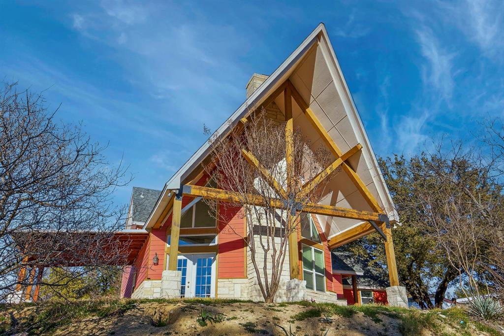 Seller is offering up to $30,000 toward the buyer’s closing costs and-or an interest rate buy-down with an acceptable offer. In addition, the preferred lender will provide an additional interest rate buy-down and up to $1,000 toward buyer closing costs for qualified buyers. Contact the listing agent for complete details.

Perched atop a wooded hillside, this refined Texas country estate offers privacy, space, and timeless character. The property features a newly built detached 1-bedroom, 1-bath guest suite with a full kitchen and living area, approx. 800 sq ft, ideal for multigenerational living, guests, or income potential.

The main residence spans over 2,200 sq ft, showcasing soaring vaulted ceilings, abundant natural light, and a dramatic 30 foot Austin stone fireplace anchoring the living space. A well appointed kitchen includes dual walk-in pantries for exceptional storage. The primary suite opens to a private balcony overlooking the treetops and is complemented by a recently updated ensuite bath.

Flexible living continues with two spacious lofts and an additional upstairs room with two closets. Three new HVAC systems ensure comfort and efficiency.

Set on 2.25 private acres with mature pecan trees, native landscaping, and visiting wildlife, the outdoor spaces are designed for both relaxation and entertaining, featuring covered patios and a newer pergola. A 16×20 powered workshop with carport and a 2023-built 30×30 concrete floor barn provide exceptional space for RVs, equipment, or recreational vehicles. Conveniently located with quick access to Downtown Fort Worth and Weatherford, and major shopping just minutes away.