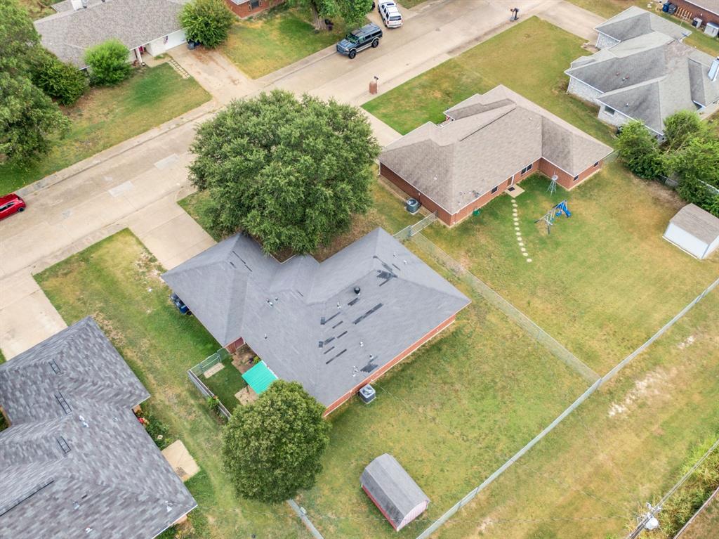 $500 Buyer's Concession for executed contract by June 30th. Welcome to a place where comfort, charm, and opportunity come together in one of Red Oak’s most inviting, well-established neighborhoods. This beautifully maintained 3-bedroom, 2-bath home with a 2-car garage sits on a generously sized lot, offering the kind of space and flexibility that truly elevates everyday living.  Step outside and imagine your future backyard oasis—whether it’s a sparkling pool, vibrant garden, play space for the kids, or the ultimate entertaining retreat. The covered back porch is perfect for morning coffee or evening gatherings, while the added storage building brings convenience and versatility to your outdoor lifestyle.  Inside, you’ll find a thoughtfully designed floor plan that blends functionality with warmth. Natural light fills the living spaces, creating an inviting atmosphere that instantly feels like home. Whether you’re a first-time buyer, looking to downsize, or simply ready for a fresh space to make your own, this home offers the perfect canvas.  Nestled in the heart of Red Oak, you’ll enjoy small-town charm with big-time growth. The area continues to thrive with expanding opportunities, including the highly anticipated Google data center nearby—bringing energy, development, and long-term value to the community. With quick access to Highway 67 and Highway 287, you’re just a short drive from the dining, shopping, and entertainment of the greater DFW Metroplex.  Cozy, connected, and full of potential—this is more than just a house, it’s a place to truly call home.