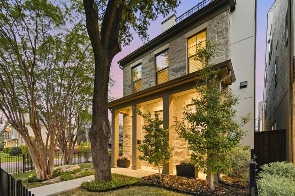 Stunning modern residence on a premium corner lot in Dallas’ coveted 75209, offering the perfect blend of style, comfort, and convenience. This exceptional 3-bedroom, 2 full and 2 half bath home spans three thoughtfully designed levels filled with natural light and upscale details. The main floor showcases a bright, open-concept layout enhanced by rich engineered wood flooring, expansive wraparound windows, and elegant wood shutters. The gourmet kitchen features a gas cooktop, premium appliances including a Miele dishwasher, beautifully illuminated glass-front cabinetry, and abundant space for entertaining and everyday living. Upstairs, the spacious primary suite serves as a private retreat with a spa-inspired bath featuring dual vanities, a soaking tub, separate shower, and a generous walk-in closet. Two additional bedrooms provide flexibility—one with its own en suite bath and the other ideal for guests or a home office—both offering walk-in closets. The third level offers a versatile bonus space perfect for a second living area, fitness room, or workspace, complete with electric shades, a half bath, and access to a private rooftop deck. Thoughtful upgrades include lighting automation, plantation shutters, electric blinds, epoxy garage flooring, built-in storage, EV charging station, and prewired for backup generator. Step outside to a beautifully designed backyard retreat highlighted by a mature tree and a custom A-frame covered patio featuring built-in TVs, heater, ceiling fan, and a wood-burning stone fireplace. Residents enjoy access to a resort-style pool, dog parks, and weekly lawn maintenance provided by the HOA. Ideally located just moments from West Highland Park and minutes from Downtown Dallas, the Medical District, and the Dallas North Tollway, this meticulously maintained home offers a low-maintenance lifestyle with luxury finishes throughout.