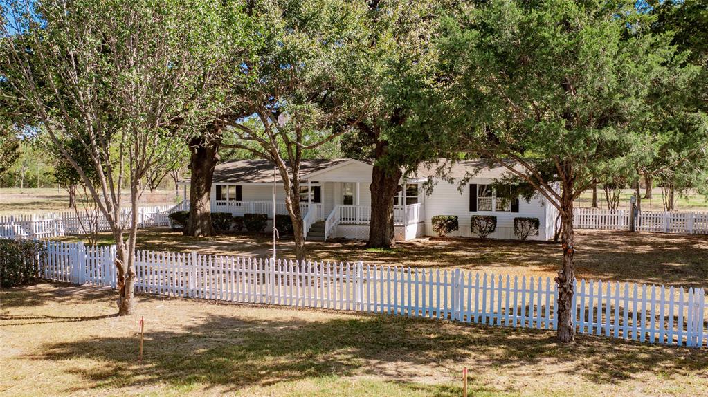 Are you looking for that picturesque country home with the white picket fence? Stop your search, here it is. Escape the concrete jungle and enjoy all nature has to provide. The two acre parcel is a beautiful mixture of towering oaks and meadow fields. It adjoins an additional 5+ acres of exclusively controlled SRA land littered with deer and other wildlife. This land backs up to Caddo Creek, a prominent tributary to Lake Tawakoni. Upon entering the home, you will immediately notice the attention to detail. This meticulously updated home features an open floor plan, spacious kitchen with island, granite counters, large living area, and a second family room with fireplace. New HVAC system and almost new roof. A custom, oversized entertainment deck is perfect for a morning cup of coffee while enjoying the serenity of Mother Nature. It is difficult to find beautiful property like this so close to the lake. Come see this one today, and bring yourself closer to nature. Special financing available to qualified buyers.