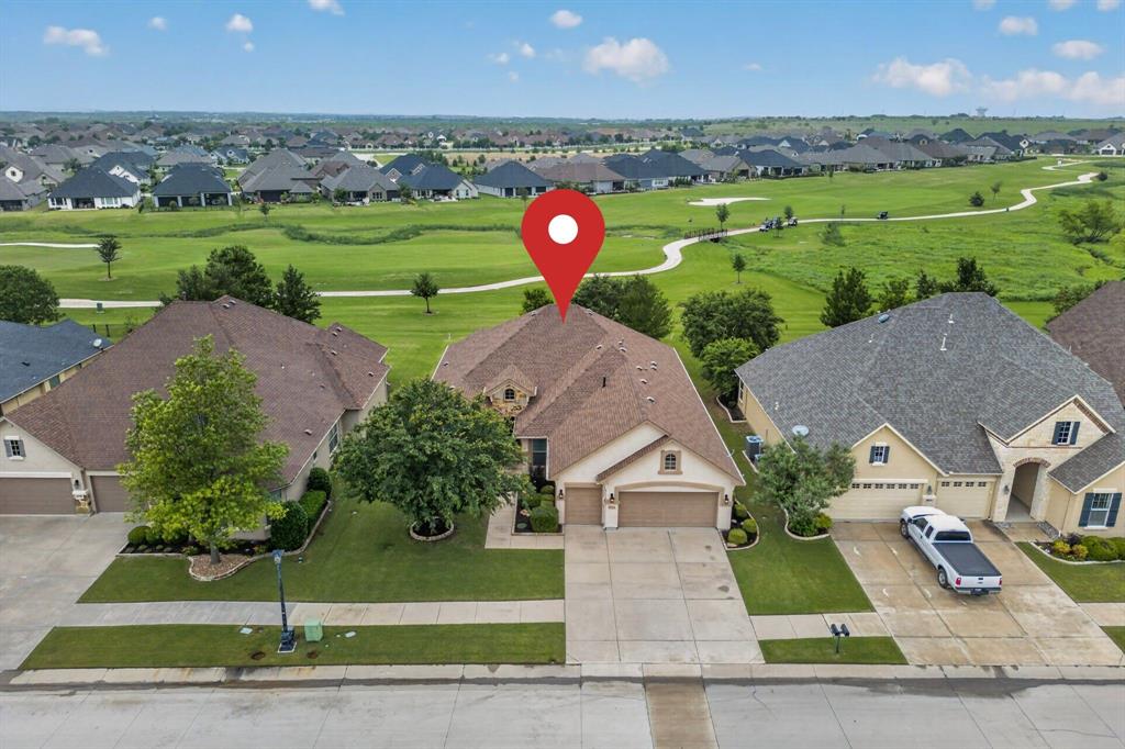 Welcome home to this beautifully maintained Lexington floor plan, perfectly positioned with a stunning view of the 8th hole on the North golf course. The home’s curb appeal shines with meticulous landscaping and elegant stone shrub borders, setting the tone for what’s inside.

Enjoy outdoor living at its finest on the extended paver patio, complete with a built-in grill, gas firepit, ceiling fan, and remote-controlled shades—ideal for relaxing or entertaining while taking in the golf course views.

Inside, the open-concept layout is filled with natural light. The living room features a built-in media center, crown molding, tray ceiling, and ceiling fan, all oriented to capture the scenic backdrop.

The chef’s kitchen is designed for both function and style, offering a large island, expansive granite countertops, a breakfast bar, abundant cabinetry, tiled backsplash, a gas cooktop, wall oven, and convenient rollout drawers. The spacious dining area easily accommodates a large table for gatherings.

The primary suite is a peaceful retreat with a bay window, crown molding, and ceiling fan. The en-suite bath boasts dual sinks, a walk-in curbless shower with a frameless glass enclosure. A second primary suite offers flexibility for guests, featuring a boxed window, dual sinks, and a shower with a built-in seat.

A third bedroom provides versatility as a guest room, office, or den.

Additional highlights include a tankless water heater, radiant barrier for energy efficiency, and a foundation drip system.

This home combines comfort, functionality, and exceptional outdoor living—all in a picturesque golf course setting.