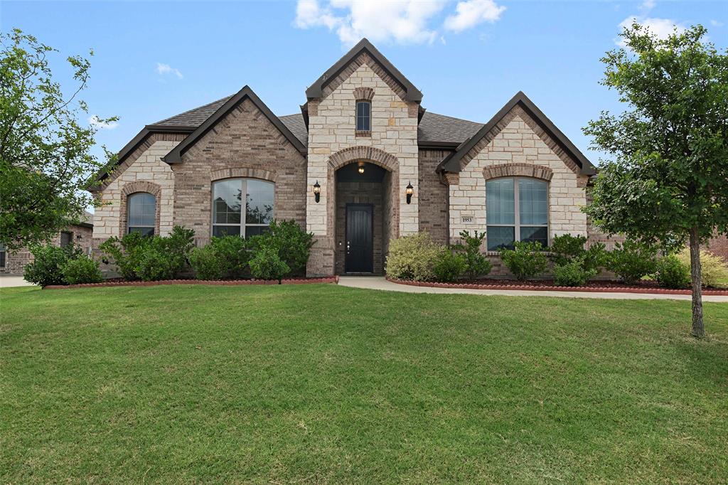 Nestled at the end of a quiet street on an oversized lot with no rear neighbors, this stunning brick & stone home offers privacy, space, and a highly functional floorplan. A swing driveway leads to both a two-car garage and a separate third-car garage with direct driveway access—perfect for a workshop, home gym, hobby space, or additional storage. Step inside to a grand, wide entryway accented by rich dark wood floors, soaring ceilings, & an abundance of natural light from walls of windows throughout the home. The open concept layout is ideal for everyday living and entertaining. The beautifully appointed kitchen features white cabinetry, pot & pan drawers, a dedicated trash drawer, built-in oven & microwave, electric cooktop, ample prep space, & refrigerator. The spacious dining area, large enough for a full size table, is surrounded by bay windows & overlooks the backyard. The inviting living room is anchored by a stone wood-burning fireplace, creating a warm & welcoming gathering space. The oversized primary suite offers a peaceful retreat with bay windows and plenty of room for a sitting area. The luxurious primary bath includes split vanities, a separate shower, garden tub, linen closet, & an expansive walk-in closet. Downstairs you'll also find two secondary bedrooms plus a private study with French doors, perfect for working from home. Upstairs, a large bonus room with a closet provides flexible space for a game room, media room, playroom, or even fourth bedroom. Outside, enjoy the privacy of a large backyard from the stone retaining wall and tall wood fence. Enjoy Texas nights on the large covered patio! There is also access to the third car garage from the backyard. You could easily extend the concrete drive and use the third garage to house your favorite toys! Feeds to highly regarded, Burleson ISD! If you're looking for a MOVE-IN READY home with flexible living spaces, exceptional privacy, and a quick commute to Fort Worth, this one checks all the boxes.