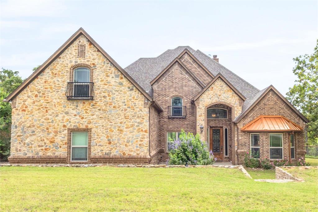 Country living on over 4 acres with No HOA, No City Taxes and No Restrictions! This impressive 4-bedroom, 3-bathroom home offers more than 3,300 square feet of thoughtfully designed living space, including a spacious game room and formal dining area. Currently serving as an office, the fourth bedroom offers a full closet and flexible use. The stunning living room is the heart of the home, featuring beautiful wood trusses, soaring ceilings, and a floor-to-ceiling stone fireplace that creates a warm and inviting atmosphere. The kitchen features granite countertops, warm wood cabinetry, a center island, and a cozy eat-in dining area. The flexible floor plan provides ample room for family and guests, while the oversized game room offers endless possibilities for recreation, a media room, or home office space. Additional highlights include a shared dual-access bathroom between two secondary bedrooms, a spacious walk-in pantry, a functional mudroom, and beautiful bay windows that fill the home with natural light. Step outside to enjoy the cleared, fenced backyard shaded by mature oak trees, creating the perfect setting for outdoor gatherings, pets, or simply relaxing and enjoying the peaceful surroundings. Enjoy outdoor entertaining on the expansive back porch complete with a built-in grill, wood burning fireplace and granite countertops. A 900-square-foot shop provides excellent space for hobbies, storage, equipment, or a workshop. Recent updates include a brand new roof & gutters installed in June 2026 and a new garage door. If you've been searching for acreage, a shop, and room to spread out without sacrificing comfort, this property delivers it all.