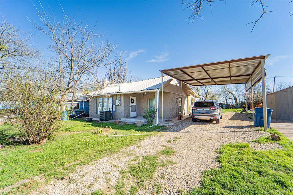 Discover the potential in this cozy 2-bedroom, 1-bath home, perfect for first-time buyers, investors, or those looking to downsize. Situated on a generous lot, this property offers a functional layout with comfortable living spaces and plenty of outdoor room to enjoy. The home features a welcoming front porch, ideal for relaxing evenings, and a practical interior layout. A large covered carport provides convenient parking and protection from the elements, while the extended driveway allows for additional vehicles or guests. Step outside and enjoy the open yard with room to garden or create your ideal outdoor space. The additional storage structure adds extra convenience for tools and equipment. Quiet setting with easy access to nearby amenities. With its affordable price point and great location centrally located in town and near an elementary school lets make this your next purchase. Call or message me to take a look today!