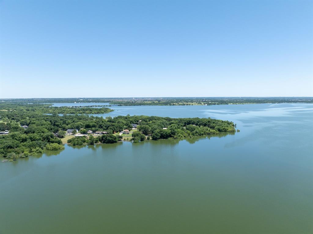 Lakefront retreat, income opportunity, and private escape all in one property located less than an hour from Dallas on the shores of Lake Lavon. This unique property offers flexibility for personal use, investment, or multi-generational living with multiple possible income strategies.

Currently operating with strong short-term rental appeal, the property has potential for six-figure gross annual STR income depending on occupancy and management. The flexible layout may also work well for mid-term rentals, long-term rentals, house hacking opportunities, rent-by-the-room concepts, corporate retreats, group retreats, or hybrid owner-occupant investment strategies.

Designed for gathering and entertaining, the property features expansive outdoor spaces, lake views, multiple living and sleeping areas, updated finishes, hot tub, firepit area, and large common spaces ideal for hosting guests or extended stays.

Opportunities like this near DFW are becoming increasingly rare as development and growth continue around Lake Lavon. Whether you're searching for a waterfront residence, weekend getaway, Airbnb investment, or flexible income-producing property, this one offers options difficult to find in today’s market. Seller is open to discuss owner financing.