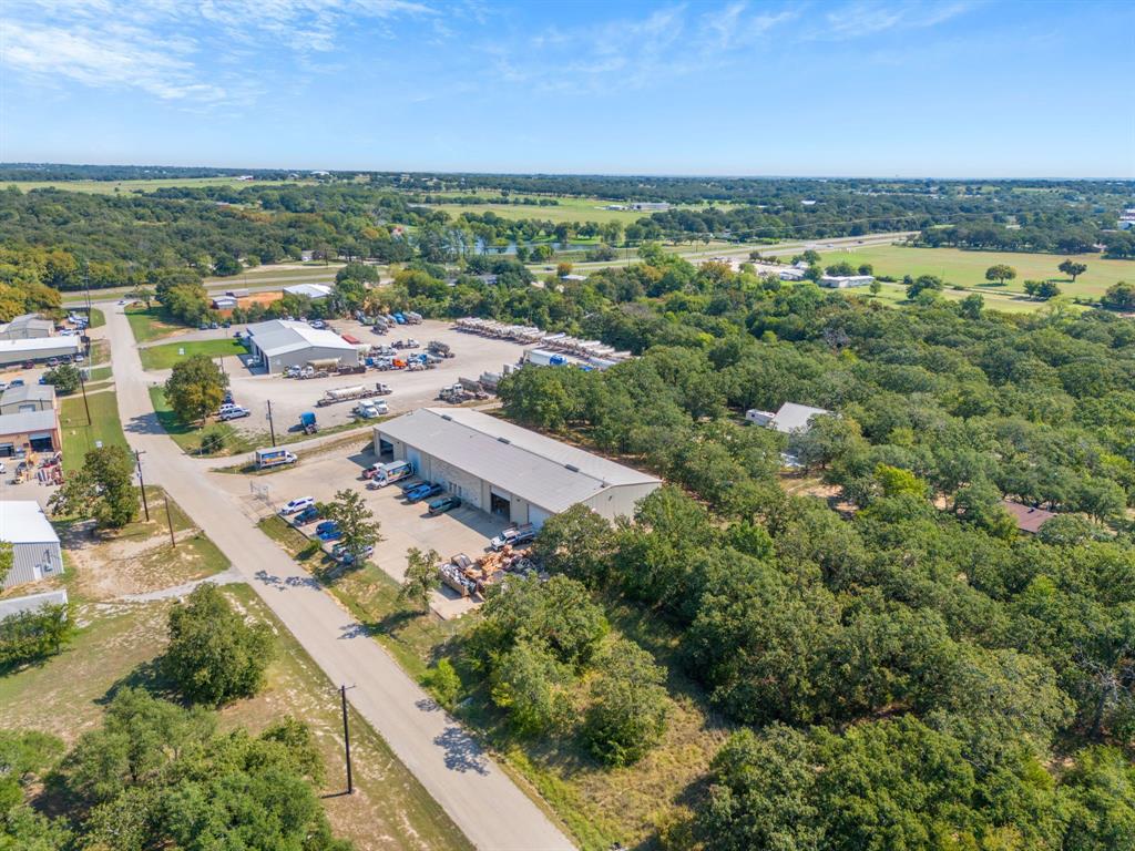 Excellent investment opportunity with a tenant in place on a NNN lease. This 12,680 sq ft fully climate-controlled industrial warehouse includes 1,200 sq ft of office space, two restrooms, a large cyclone tool crib, and four oversized 14’ x 18’ roll-up doors. The building features 20-foot side walls, high ceilings, and 3-phase electric service, making it ideal for a variety of industrial uses. Situated on a 1-acre lot outside city limits, the property operates on a water well and septic system and includes a concrete parking lot. The current tenant has two years remaining on a NNN lease, which will convey with the sale, offering immediate and stable cash flow for the new owner. Don't miss this chance to let your money make money!