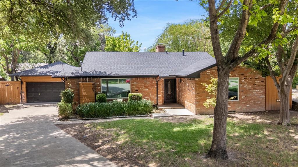 Mid-Century Modern charm meets designer updates in this stunning 1957 brick bungalow. Boasting 1,547 square feet of meticulously curated living space, this home perfectly balances retro character with high-end contemporary renovations. From the street, you are greeted by fresh, trending exterior trim colors that beautifully accentuate the classic mid-century architecture, anchored by a new roof installed in July 2023. Inside, the entire interior was professionally repainted in June 2026, showcasing flawlessly refinished original hardwood floors that flow throughout the main living areas. The heart of the home features a cozy fireplace in the living room, where expansive sliding glass doors look straight out to your private backyard oasis. Step through the doors to find an inviting, 5-foot-deep in-ground plunge pool that is absolutely perfect for summer relaxation and effortless outdoor entertaining. The completely redone chef’s kitchen is a true showstopper, boasting an uplifting shade of summer blue cabinetry, gorgeous butcher block countertops, a deep farm-style sink, and a premium gas double oven. Retreat to the primary suite featuring a luxuriously remodeled bathroom complete with a modern walk-in shower and a stylish new vanity. The second bathroom pays homage to the home's heritage, showcasing a meticulously preserved original pink retro bath in excellent vintage condition. Nearby, the versatile second bedroom is exceptionally spacious, easily accommodating a built in Murphy bed while still leaving plenty of room for a dedicated home office setup. Located just an 8 minute drive to White Rock Lake, this home combines peace of mind upgrades with irreplaceable mid-century soul, this turnkey property is a rare find that is ready for its next chapter.