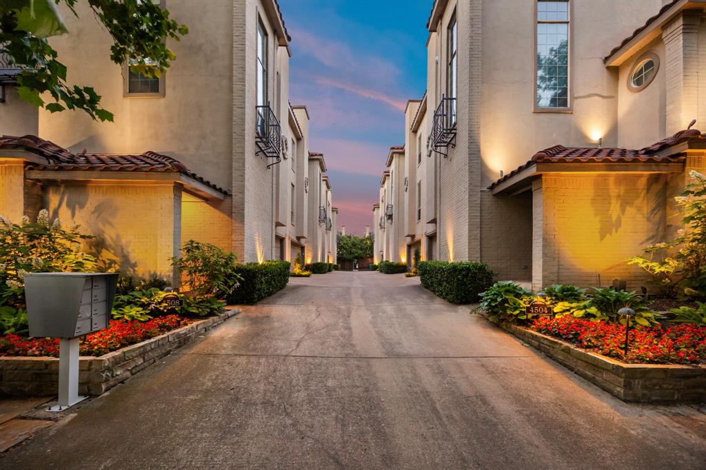 Tucked behind a gated entrance in a quiet Oak Lawn enclave, this updated three-level residence offers a lock-and-leave lifestyle just minutes from Highland Park, Turtle Creek, Uptown, and some of Dallas’ best dining and shopping. Inside, the home feels polished and elevated with fresh interior paint, updated drywall texture, recessed lighting, hardwood floors, plantation shutters, crown molding, and timeless trimwork. Generous living and dining spaces are anchored by a gas fireplace, with a wet bar and beautifully defined dining room creating an ideal setup for entertaining. The kitchen features granite countertops, stainless steel appliances, gas range, abundant cabinetry, and great natural light. The flexible floor plan includes ensuite bedrooms across all three levels. The first-floor bedroom opens directly to a private fenced patio with turf and hot tub, while the third-floor primary suite offers new carpet, enhanced closet lighting, and a beautifully renovated bath with dual vanities, freestanding soaking tub, and oversized glass-enclosed shower. Additional highlights include a balcony off the kitchen, attached garage, and recent cosmetic updates throughout. Move-in ready with a tucked-away feel in the heart of Dallas.