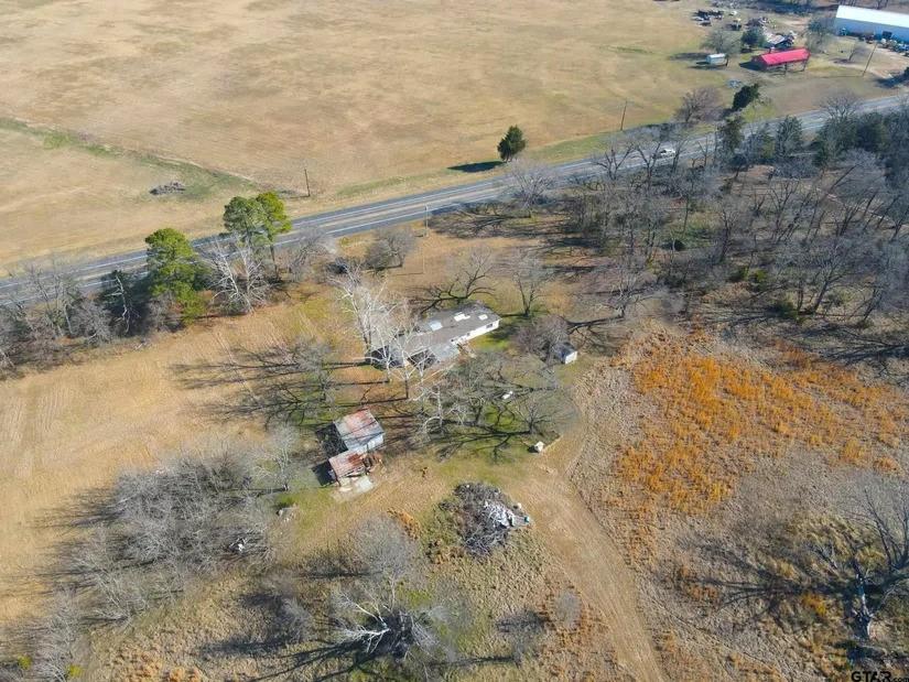 Property is an estate and consists of beautiful acreage with pastures and trees, 2 ponds & partial ownership of a third pond shared with a neighbor, older farmhouse and scattered outbuildings. This property was acquired in several parcels over time and the heirs do not have a survey. The land was used for cattle in the past but recently used for hay production. Farmhouse is not given any value and is being sold as is, which means the sellers will make NO REPAIRS BUT it certainly can be revived to be a homestead for the new owners. The REAL Value is in the land, ponds, utilities already on site, AG exemption, and location which is convenient to dining, shopping, medical facilities in both Sulphur Springs and Winnsboro plus great fishing at several area lakes. The Como Pickton ISD is also a big plus. This property has so much to offer, don't let it get away. The country life is calling.  Call Agent for Showing.