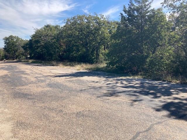 Come build an amazing home surrounded by trees on nearly 1.5 acres located in Joshua ISD and easy access to city convenience, schools and shopping. Use your vision to create your own outdoor paradise and enjoy the seclusion and privacy of country living. Property needs cleanup and removal of old structures and clearing of some underbrush and is priced accordingly but the opportunities to make it special are endless. Property already had water and electricity from a previous mobile home and sits with 200 feet of paved frontage. No known restrictions and plenty of room to enjoy all of your animals, projects, parking and toys. An ideal project that allows you and your family to do your own thing!
