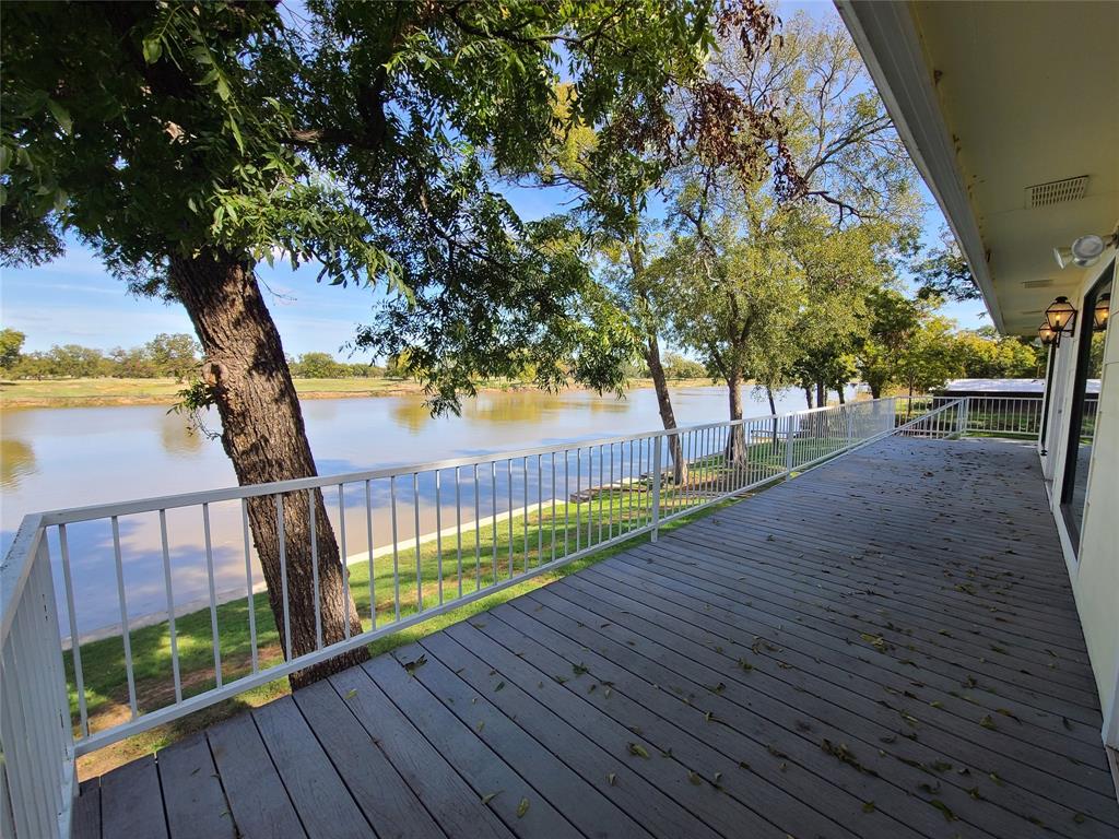 Nestled along the picturesque banks of the Brazos River, this stunning 3-bedroom, 2-bathroom home boasts a unique lower-level 3rd bedroom or bonus room for summer guests. The heart of the home is the gourmet kitchen, featuring an expansive 8' center island, where culinary dreams come to life. Prepare meals while enjoying breathtaking riverfront views via the oversized windows. Oversized living area seamlessly connects w-kitchen. This location of the Brazos River a wide range of water activities, from skiing and fishing to kayaking and all your favorite water sports. Conveniently located an equal distance from Weatherford and Granbury, both reachable in under 15 minutes. Experience the best of both worlds with easy access to city amenities, yet the tranquility of a riverfront retreat. Cool off in the tranquil community pool or launch your boat with ease using the communities private boat ramp and explore the river's hidden gems. Granbury Lake is accessible from this location via water.