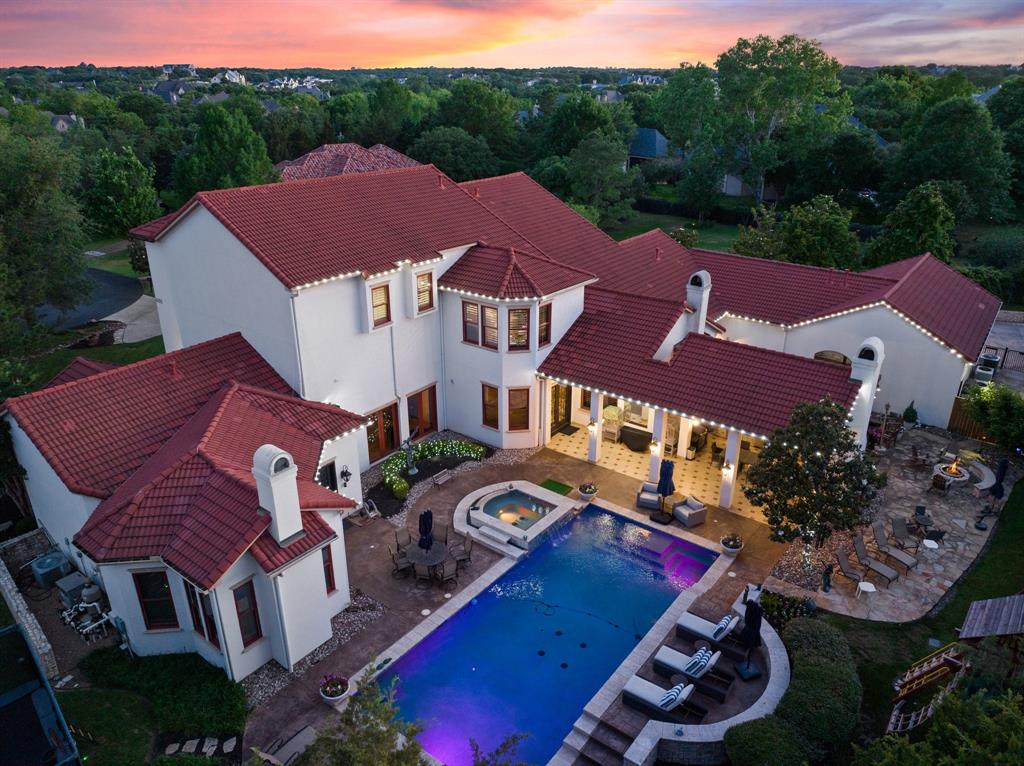 Zoned to Carroll ISD and Westlake Academy, this Kensington Custom Homes masterpiece sits in the gated Glenwyck Farms community. Nestled on a private cul-de-sac, it boasts travertine and wood floors, elegant lighting, Crestron home automation, and a whole-home generator. The gourmet kitchen features Viking appliances, an AGA stove, and custom alder cabinetry. The luxurious primary suite offers a fireplace, spa-like bath with a steam shower, and a cedar-lined closet. Additional highlights include a private study, guest suite, media room, wine room, and game room with a full bar. Bolivian Mahogany doors and Raymond Enkeboll carvings add timeless charm, while foam encapsulation, four HVAC zones, and a 125-gallon re-circulating hot water system provide efficiency. Outdoors, enjoy a Claffey-built heated pool and spa, koi pond, covered patio with a fireplace, grilling station, and pool bath—all just 10 minutes from DFW Airport.