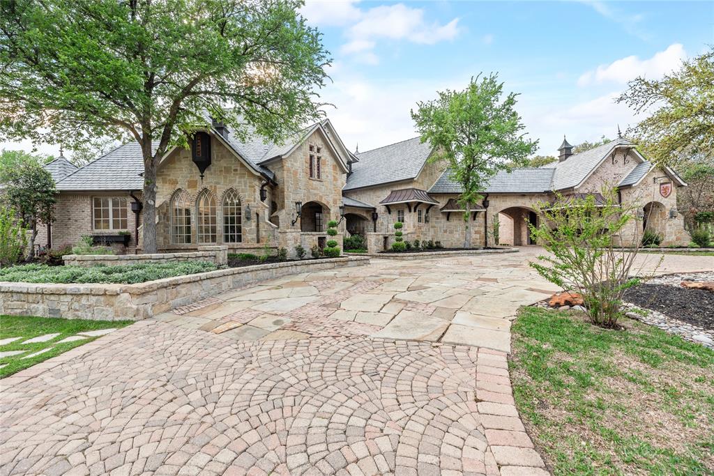 Experience unparalleled, timeless elegance in this stunning 6,100 sq. ft. estate, perfectly situated on a fairway in the prestigious, 24-hour gated and guarded golf course community, The Estates at Tour 18. Beautifully updated, this 4-bedroom, 6-bath home features soaring cathedral ceilings, a fireplace in the primary suite, and exquisite indoor and outdoor living spaces.
Step outside to your private oasis, showcasing a saltwater pool and spa, a cabana, a serene koi pond and inviting fire pit. Enjoy endless recreation on the custom sport court—for pickleball, tennis, basketball or more, —complete with stadium lighting. The heavily treed lot offers privacy, while the circular drive and porte-cochère provide a grand entrance. 
Located within award-winning Argyle ISD and just minutes from top private schools, fine dining, and premier shopping, this home offers unbeatable convenience—only 15 minutes to DFW Airport and 35 minutes to Love Field. With a spacious 4-car garage - including 500 square feet of attic storage - and easy access to world-class amenities, this estate beautifully blends luxury, comfort, and location.