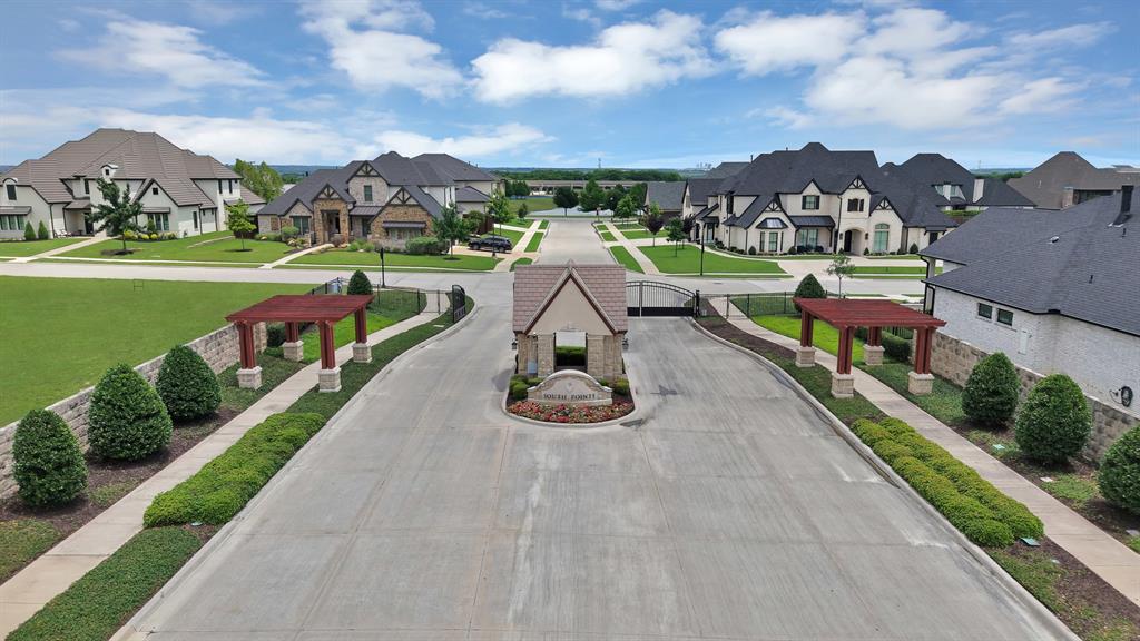 BUILD WITH YOUR CHOICE OF BUILDER!! RARE OPPORTUNITY to own one of the LARGEST AVAILABLE LOTS in the GATED SECTION of South Pointe in Mansfield, Texas — priced well below the current per-square-foot land value of comparable lots in this community. At .478 acres, this flat, square, OVERSIZED CORNER LOT offers the footprint and flexibility to build the custom home you have been designing in your head. Lot is cleared, fully sodded, and ready for building.
This lot is approved to build with YOUR CHOICE OF BUILDER making it the ideal opportunity for an end buyer ready to invest in a one-of-a-kind custom build. 
South Pointe is one of Mansfield's most desirable master-planned communities. This section of South Pointe is especially exclusive, featuring a GATED ENTRY with stone monument, iron gate, cedar pergola columns, and 24-hour electronic access. South Pointe has tons of amenities. A large 4,000 sq ft clubhouse with a resort style pool and cabanas, miles of bike trails, nine parks and fishing ponds. This section's amenities include a stocked pond with aerating fountain, tree-lined walking paths, manicured greenspace, and streets lined with established custom homes — all within a controlled access setting. Buyers building in South Pointe choose it for the sense of place, the caliber of surrounding homes, and the lasting value that comes with a gated luxury community in the heart of Mansfield.
Located in MANSFIELD ISD with quick access to Highway 360, this lot puts you within minutes of major DFW employment corridors, retail, dining, and entertainment in both Mansfield and Arlington. The combination of location, lot size, builder pedigree, and below-market land pricing makes this one of the most compelling custom home opportunities currently available in South Pointe or anywhere in south Mansfield.
CUSTOM HOME LOT. GATED COMMUNITY. MANSFIELD ISD. BUILD-READY.