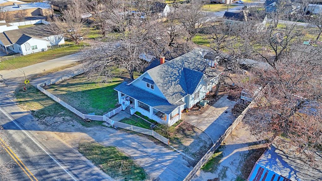 Step back in time with this beautifully maintained 1918 two-story home in the heart of Alvord. Offering 4 bedrooms, 3 baths, and 2,906 square feet, this timeless property blends historic charm with thoughtful updates for modern living. 
From the moment you arrive, the large front porch welcomes you to slow down and stay awhile. Inside, you’ll find an impressive staircase, abundant natural light from oversized windows, and new luxury vinyl plank flooring throughout. The inviting kitchen serves as the heart of the home, with plenty of space for friends and family to gather and create lasting memories.
Situated on a spacious 0.46-acre corner lot, the property is enclosed by a classic white picket fence and shaded by mature pecan trees, creating a picturesque setting. The location is ideal—just a short distance to Alvord ISD, the grocery store, post office, bank, and more.
Bonus features include a 2,000+ square foot commercial building with six rooms and two restrooms—perfect for a business opportunity, office space, studio, or additional income potential. A storm shelter in the backyard adds peace of mind.
This rare Alvord gem offers character, space, and versatility, all in one remarkable property. Motivated seller!  Check out the courting bench..the ceilings...the custom and original wood work...the staircase...There are some smart features in the home. Surround sound! Water filtration system! All information herein deemed reliable but not guaranteed. Buyer and Buyer agent should verify all information in this listing, flyers and advertising, including but not limited to the sq footage, schools, taxes, easements, restrictions, zoning, etc...