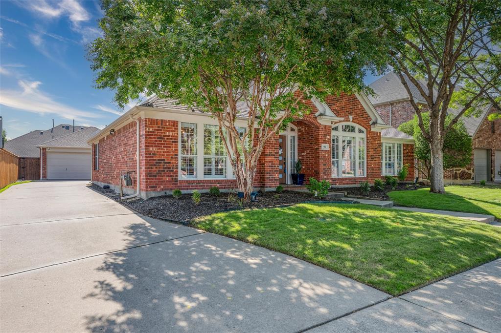 Welcome to easy, low-maintenance living with upscale style and thoughtful design in sought-after Stonebridge Ranch. Located on a quiet, tree-lined street in McKinney, this beautifully updated home offers the comfort and convenience of main-floor living, with essential spaces on the entry level—making it feel practically single-story.

From the moment you step inside, you'll notice the calming designer palette, abundant natural light, and high-end finishes that create effortless sophistication throughout the home.

The heart of the home is the show-stopping kitchen, featuring quartz waterfall countertops, a full-height backsplash, and upgraded GE Café appliances that blend performance with style. Whether preparing a quick meal or entertaining guests, this space delivers beautifully on both form and function.

Oversized rooms throughout provide flexibility and breathing room. Living areas are open yet defined, allowing for gatherings, entertaining, or quiet relaxation. Upstairs, rich hardwood stairs lead to additional living space perfect for guests, hobbies, or extended household needs.

Storage is anything but an afterthought—custom closet built-ins maximize every inch of space for organized living. The dedicated home office stands out with impressive built-in cabinetry and workspace that makes working from home both elevated and efficient.

Spa-inspired bathrooms feature sleek fixtures, tile showers, and a tranquil aesthetic designed to feel both luxurious and calming.

Step outside to your intimate patio retreat—perfect for morning coffee, evening wine, or relaxed outdoor dining framed by mature landscaping.

Residents enjoy the exceptional lifestyle of Stonebridge Ranch, known for scenic lakes, miles of trails, parks, and resort-style amenities including the Stonebridge Ranch Beach & Tennis Club, with convenient access to shopping, dining, and historic downtown McKinney.