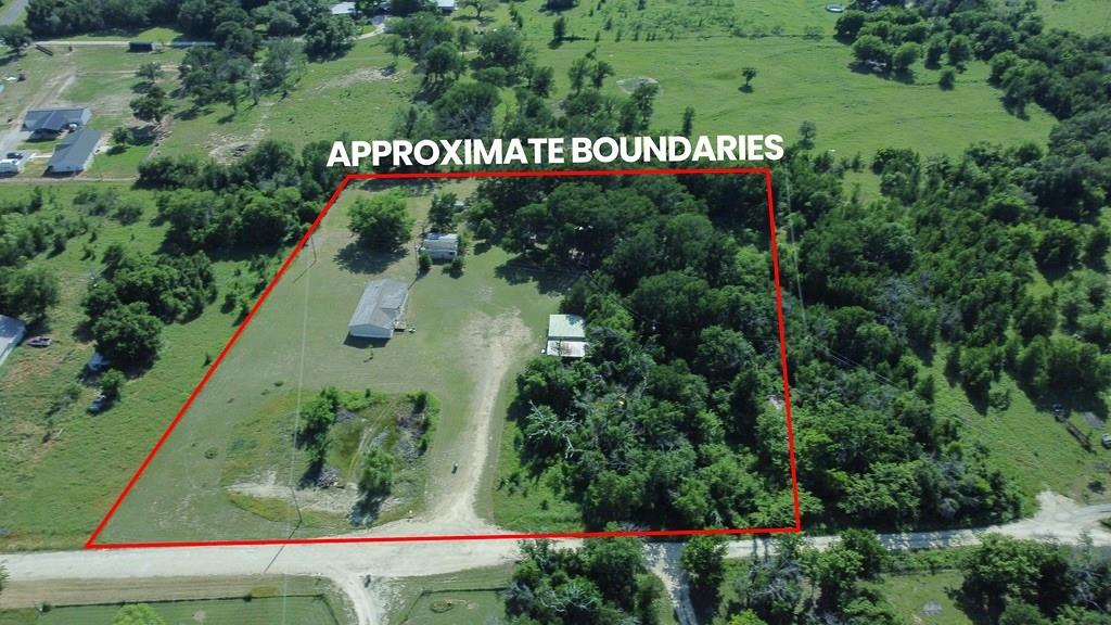 Escape to the country on this beautiful 5-acre wooded property just outside Dublin city limits. Surrounded by mature trees and abundant privacy, this unique property includes two mobile homes and endless possibilities. Whether you're looking for a family compound or your own quiet Texas getaway, you'll appreciate the space, shade, and peaceful rural setting.

The primary double-wide mobile home is nestled down in the woods and has 3 bedrooms and 2 bathrooms, with a front porch perfect for enjoying the evening.  The property being sold is 5 acres total with several outbuildings that need to be demolished or repaired. There is a covered single carport in the front, as well as another one that can accommodate an RV or mobile home.  Some or all appliances might convey, depending on the owner's next living arrangements.  

There is a second mobile home on the property that needs repairs to be livable.  It has not been lived in for 4 years, and the heirs are in the process of obtaining the title for it to be sold with the primary mobile home, or to be repaired, sold, and moved off the property.  There is also a truck and frame of an existing mobile home in the woods to the north of the property.  The buyer will be responsible for removing those items if they wish to do so.