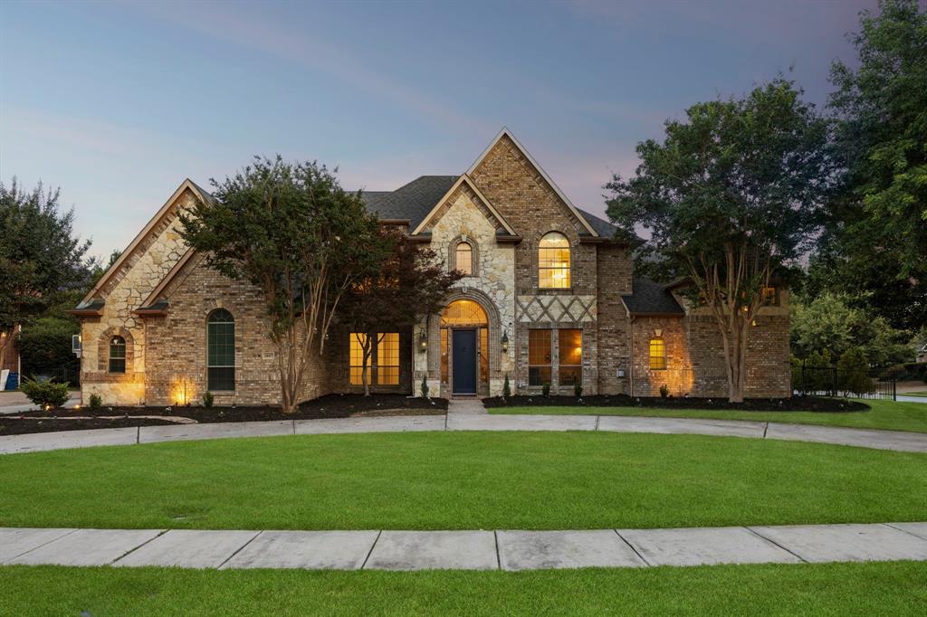 Nestled on a sprawling 0.509 acre corner lot within a cul-de-sac, this beautifully updated estate offers picturesque lake views in the coveted Southlake Woods community. Featuring five spacious bedrooms, and five baths, this exceptional residence seamlessly blends timeless elegance with modern comfort. Designed for both entertaining and everyday living, the light filled floor plan showcases soaring vaulted ceilings, abundant natural light, and striking fireplace that anchors the sophisticated living space. The gourmet kitchen flows seamlessly into the dining area and spacious family room, creating the perfect gathering space. The primary suite offers a private retreat complete with a sitting area, closet system, and spa-inspired bath. A distinguished executive study features custom built-in bookcases, wood-beam ceilings, and a warm fireplace, providing an elegant and inspiring workspace. Step outside to your private backyard retreat complete with a sparkling pool and spa, outdoor kitchen, and expansive covered living area. Residents of Southlake Woods enjoy amenities including a community pool, pool house, tennis courts, playgrounds, and scenic lake.