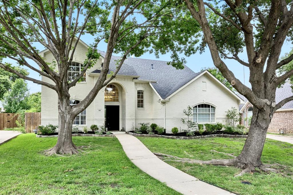 Welcome to 49 Cimarron Drive, a turnkey retreat tucked away in the heart of Trophy Club where modern updates meet effortless style. This four-bedroom 2.5 Bath 2 Car home with pool and spa has been thoughtfully reimagined. New flooring throughout, updated kitchen, baths, paint, fixtures and lighting. This refreshed home offers an open floor plan bathed in natural light and wrapped in cozy, neutral tones. The kitchen serves as the home’s vibrant centerpiece, boasting new cabinets, sleek quartz countertops, a gas cooktop, stainless steel appliances and a large island perfect for morning coffee or evening prep. Whether you're cooking or lounging by the stylish fireplace in the living room, you’ll enjoy beautiful views of the backyard. For those who work from home, the formal dining area or one of the bedrooms offers the perfect flexibility to create a quiet, dedicated office space or a 3rd living space. The downstairs primary suite is a true sanctuary, positioned to overlook the pool and expansive yard. It features a spa-like bathroom with a garden tub, a separate stand-up shower, a double vanity, and a spacious walk-in closet. Upstairs, a versatile living-media room provides the perfect backdrop for movie nights or play, alongside three additional comfortable bedrooms. Step outside to your own private getaway. Covered patio, sparkling pool and spa featuring brand-new tile and large green space for play is ready for year-round enjoyment. Location is everything here. You are just blocks away from local trails and golf course, walking distance from Lakeview elementary, with quick access to major highways and shopping. Established neighborhood, mature trees and no HOA. Plus, being only 15 minutes from DFW Airport makes travel a breeze. Every detail has been handled—all that’s left is for you to move in and enjoy the Trophy Club lifestyle.