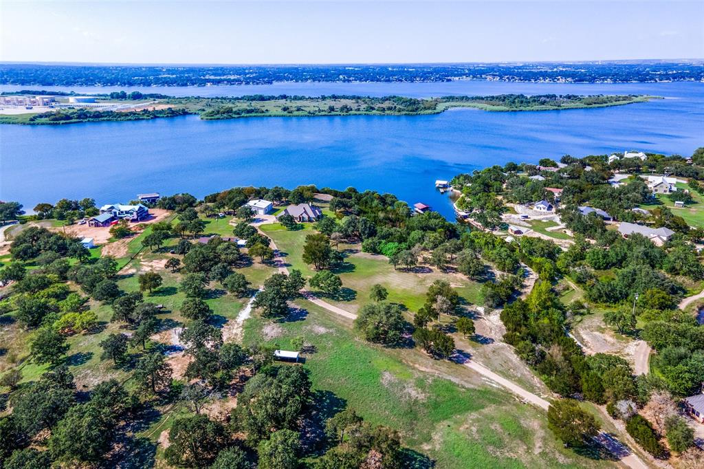 *EXQUISITE MAINBODY LAKE GRANBURY HIGHLY SOUGHT AFTER ACREAGE ~Welcome to BRAZOS RIDGE RANCH~ A PRIVATE ESTATE on one of the BEST parts of Lake Granbury with TWO RESIDENCES PLUS A SHOP tucked away for exclusive enjoyment. Private gated entry onto 25+ acres with lush mature trees; BREATHTAKING VIEWS; Beautiful main house features 3 huge bedrooms PLUS a MASSIVE BONUS ROOM, 3 full baths; 3 CAR Garage; enclosed sunroom; FANTASTIC 50x50 WORK SHOP offers 3 bays, 14ftH x 12ftW doors, 220 & 110 Electric, hydraulic lift, & storage room inside; GUEST HOUSE has 3 bedrooms plus huge bonus room; GORGEOUS MAINBODY LAKE LIVING; GREAT FISHING SPOTS, & AMAZING VIEWS. Cleared drive path to the lake. Lots of Possibilities here! FANTASTIC PRIME AREA for DEVELOPING a lakeside community! The serenity of this private lake estate is captivating with endless potential! Partially Ag Exempt.* Possible to split up acreage for an awesome development or private family estate with ample room to build other homes*