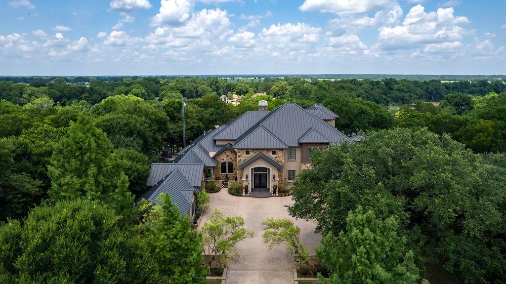 Welcome to your beautiful gated estate home with 80 acres located along the Brazos River in Bosqueville ISD. What do you want in a home? This home has it all.  If entertaining is your thing...entry opens into a large open floor plan where ceiling soars to 22ft. Kitchen has two islands,2 sub zero refrigerator/freezers, Viking range with 6 burners, griddle, grill and double ovens. Wine fridge, two dish washers, trash compactor, butlers pantry, walk-in pantry, ice maker, two kitchen islands with sink in island, warming drawer, and microwave finish out the indoor kitchen entertainment.  The bar area has 4 refrigerator drawers, sink, ice-maker and microwave.  If you want to entertain outside by the pool the outdoor kitchen has all Viking appliances-large grill, burner, warming drawer, double-sink and built-in ice chest. Want to cozy up to the fire? Large fireplace with mantle that extends to the 22ft ceiling is in main living area but don't limit yourself. You can also enjoy the fire place in the den, the main bedroom and main bath. If outdoor fire is your thing then enjoy large fireplace on porch by the pool, down along the river at the boat dock/cabana area or the stone gazebo and fire pit area. Get all your work done in his and her offices.  After your work out in the exercise room with professional equipment head to the indoor sauna or relax in the spa like main bath with steam shower.
Do you like going to the movies? No need to leave home. The theater room with reclining theatre chairs and kitchenette for snacks and movie popcorn are waiting for you to view the latest hits or the classics.
Maybe your guest are the outdoor type, so set up the skeet shooting, archery or head to the river where you can launch boats from your private paved boat ramp or lower your boat from your boat lift in the covered dock area.
The bedrooms are located on each level of the home with an ensuite bath and wet bar area. Don't worry with the stairs--take the elevator to your personal su