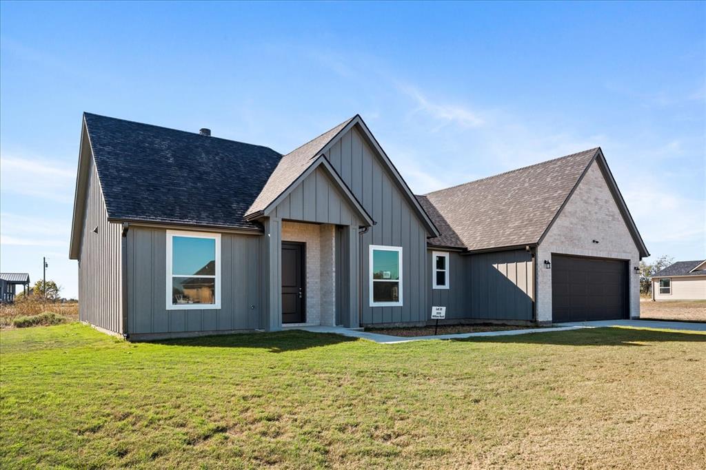 Beautiful 4 bedroom 2 bath modern farmhouse board and batten siding and brick home sitting on 1 acre lot. Home has a split floorplan with luxury vinyl and ceramic tile flooring. Walk in the front door to a spacious oversized great room that opens to the kitchen and dinning area. One of the 4 bedrooms is separated from the other two secondary bedrooms and could be used as a home office or a second living area. The primary bedroom is spacious and the bath has double vanities, large soaking tub, oversized shower and nice walk in closet. The garage has an opener and is oversized for extra storage. Owners are motivated to sell.