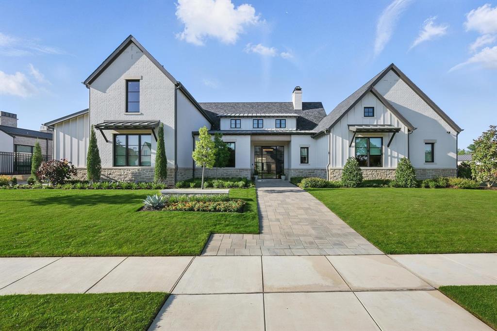 Welcome to 2619 Park Grove Loop—an exquisite modern ranch-style estate by SCH Homes Builders, nestled in the exclusive gated community of Stony Brook in Southlake. This 5,137 sq ft residence masterfully blends reclaimed brick, wood, and metal finishes in a sophisticated one-and-a-half-story layout. With 5 spacious bedrooms, 5.5 bathrooms, and a private office, the home offers both function and luxury. The chef’s kitchen is a culinary dream, featuring commercial-grade appliances, double ovens, two dishwashers, a walk-in pantry, built-in refrigerator, and eye-catching granite counters. Expansive glass walls open the main living areas to a heated and cooled covered patio with power blinds, seamlessly connecting to a south-facing pool and spa, firepit, and low-maintenance yard with crushed granite and turf. Iron fencing frames tranquil views of the greenbelt and pond. The primary suite is a serene retreat with a spa-like bath that includes dual vanities, a garden tub, a luxury shower with body sprays, and a custom walk-in closet. Additional highlights include a media room with blackout shades, Lutron smart lighting, hardwood and tile flooring, electric shades in all bedrooms, a built-in wine cooler, energy-efficient features such as foam encapsulation and a tankless water heater, and a split 3-car garage with epoxy floors and extra storage. For added peace of mind and year-round comfort, the home is equipped with a whole-house generator. Ideally located just minutes from Southlake Town Square and top-rated Keller ISD schools, this home offers the perfect blend of upscale living, convenience, and security.