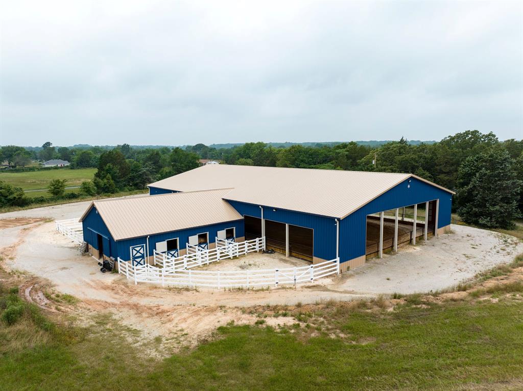 Welcome to Golden Ranch, an exceptional equestrian property nestled on approximately 10 beautiful acres in Canton, Texas, home of First Monday Trade Days.  This property features a comfortable and well maintained 2,624 sq ft Solitaire manufactured home, 4BR, 3 BA, built in 2011- ideal as a primary residence, weekend retreat, or ranch hand quarters. Your welcomed with an electric iron security gate, circle drive, fenced and cross fenced pasture, a pond and scattered trees.  The kitchen has recently been remodeled, including new granite countertops and cabinets with pull out and soft close drawers, huge island  and luxury vinyl plank  flooring.  The crown jewel is a massive 12,704 sq ft covered arena and stable, perfect for training, competitions and year-round riding regardless of weather conditions.  The impressive main barn has electric, water and WIFI and adjoins with the arena.  It offers 6 spacious horse stalls with 6 strategically placed fans and self-waterers for optimal efficiency and animal care, a dedicated tack room for equipment organization and dry food storage and a functional wash bay.  Additional facilities include a barn with concrete flooring and electricity for equipment storage and maintenance with tack room and three or more horse stalls.  Located on county road frontage and two entrances with quick Highway 64 access, the property offers excellent connectivity to Tyler, 32 miles and Dallas, 69 miles.  This complete, professionally-designed horse operation represents a rare opportunity in one of Van Zandt County's most desirable agricultural regions, perfect for private equestrian retreats or commercial training facilities.  Come see this great property!!