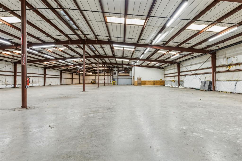 The McKean Carper Miller Real Estate Group at Paragon Realtors is pleased to present this exceptional 22,000 SF warehouse-office space situated on a generous 4.229 acre lot. Boasting 212 feet of prime frontage on the I-30 service road, the property offers outstanding visibility and easy access, making it ideal for a wide range of industrial or commercial uses. Zoned for light industrial, the building features 18.5 foot clear ceiling height in the warehouse, perfect for vertical storage and operational flexibility. Four loading docks enhance logistical efficiency, while the expansive lot provides ample room for future expansion or additional parking. This property is a rare opportunity to acquire a versatile, high-exposure commercial asset in a strategic location.