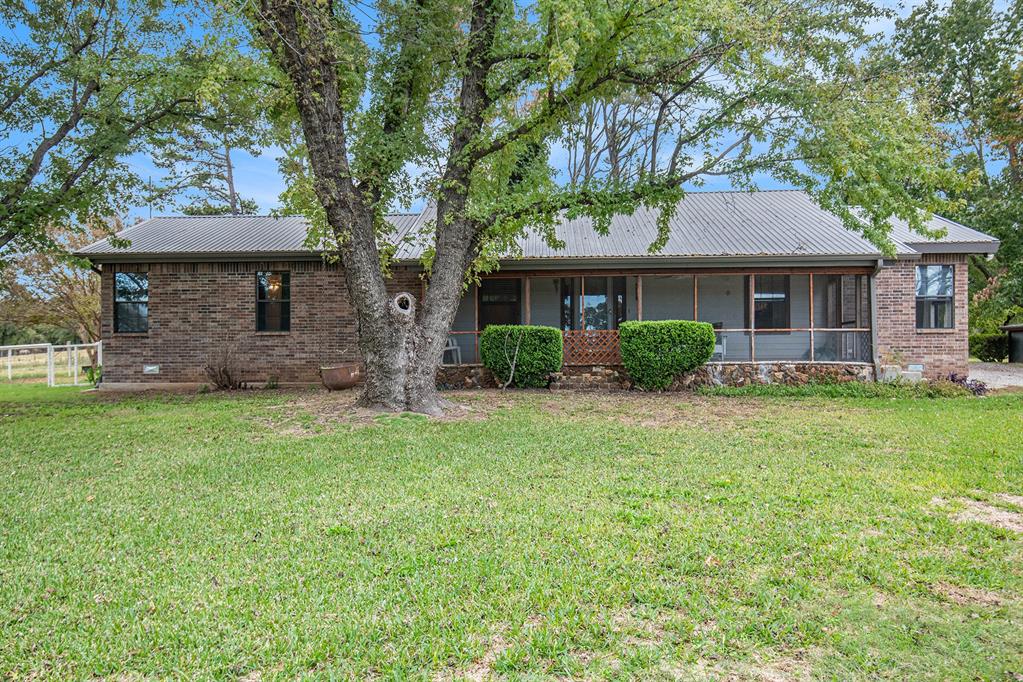 Escape to your secluded haven, a paradise for multi-generational families yearning for privacy and a chance to embrace self-sufficiency. Nestled within the lush embrace of towering trees, this 9.5-acre Boyd ranch, ensconced behind a secure fence and gate, presents two charming homes, one 2BR 2BA, 2137 sq ft, with room for additional bedrooms, and a 2BR 1BA, 900 sq ft guest house, a formidable 13' x 11' concrete bunker primed as a storm shelter, and a family-sized in-ground pool for endless moments of relaxation. Further enriching this idyllic property is a spacious 30' x 40' workshop, complete with two garage doors, a classic barn with corrals, chutes, and pens for your livestock. Your stock will revel in the abundance of pastureland at their disposal. Amidst this rustic tableau, a working windmill spins gracefully, complemented by three dependable water wells and a serene pond. But there's so much more to discover, and words alone can hardly capture its essence.