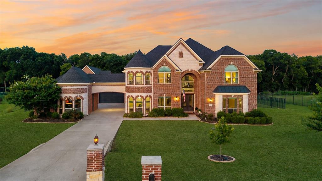 There is a version of your life that does not require a vacation to feel like one. It requires the right address. 1545 Sara Cove in Lucas is it. Step out the back to the beautifully sized 2.65-acre homesite and resort living takes over.  Spacious outdoor living, a pool and spa with cascading waterfall, a covered outdoor living space with fireplace and built-in kitchen, a fire lounge made for long evenings and star gazing. Adjacently, the almost 2000 sq ft additional unit offers it all—bar, gym, office, private guest quarters, with overhead doors that open directly to the water, ideal for entertaining, wellness, remote work, extended stay guests or even a private retreat. Inside, curated selections create a warm yet sophisticated feel, including reclaimed wood accents, cedar beams, updated lighting, custom cabinetry finishes, matte black and oil-rubbed bronze fixtures, and a timeless neutral palette. The kitchen offers rich contrast with upgraded island and butler’s pantry cabinetry, detailed hardware, designer backsplash selections, and stylish faucet upgrades for dinners worth remembering. The primary suite is a true retreat with spa-inspired finishes, stacked stone accents, custom beams, leathered Black Pearl countertops, upgraded shower tile, rain showers for two. This Lucas property delivers an exceptional blend of privacy, function, and luxury Texas living. Brand new roof!