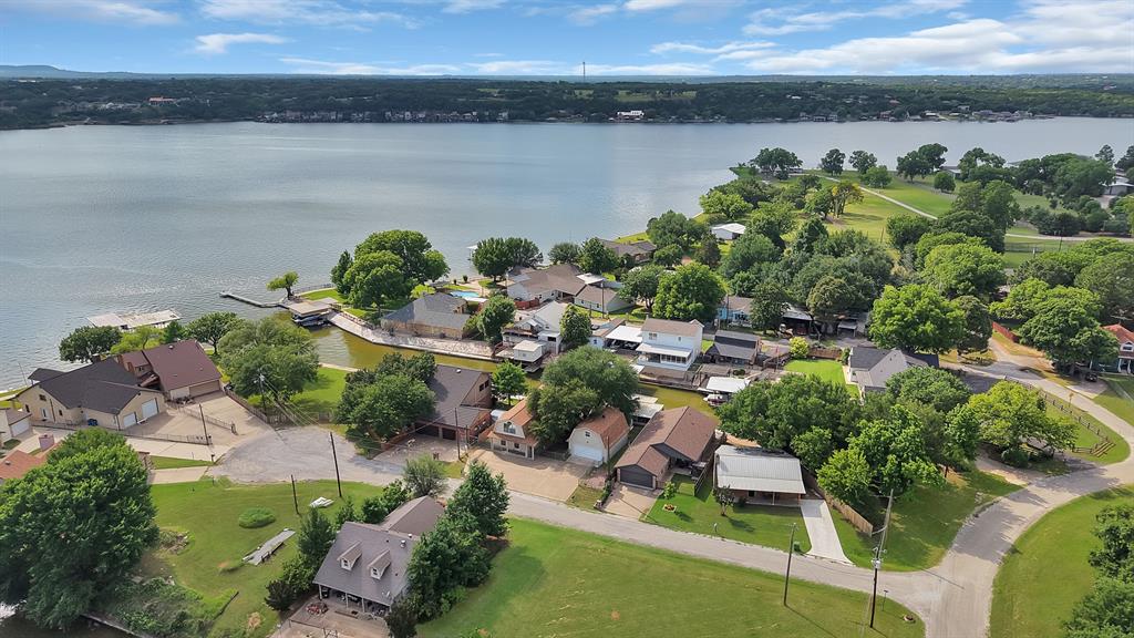 Experience the best of Lake Granbury living in this beautifully maintained waterfront home, perfectly situated on a peaceful canal with quick and easy access to the open water. Whether you're looking for a full-time residence, weekend getaway, or vacation home, this property offers the ideal blend of comfort, recreation, and relaxation.

Boating enthusiasts will love the private boat dock with lift, while anglers, kayakers, and paddleboarders can enjoy direct access to the lake right from their backyard. The expansive covered outdoor entertaining area is perfect for hosting family and friends, watching sunsets, grilling, or simply relaxing by the water.

Inside, you'll find over 2,300 square feet of inviting living space with generous room sizes, abundant natural light, and flexible living areas designed for everyday living and entertaining. The spacious layout provides comfort and functionality while maximizing views of the peaceful waterfront setting.

Located in one of Granbury's most desirable lake communities, you're just minutes from Historic Granbury Square, local restaurants, shopping, golf courses, parks, and year-round community events. Spend your days boating on Lake Granbury, fishing from your private dock, enjoying waterfront dining, or exploring everything this vibrant lake town has to offer.

Affordable waterfront opportunities with a private dock and direct lake access are becoming increasingly difficult to find. Don't miss your chance to own your own piece of Lake Granbury and enjoy the lake lifestyle you've been dreaming about.