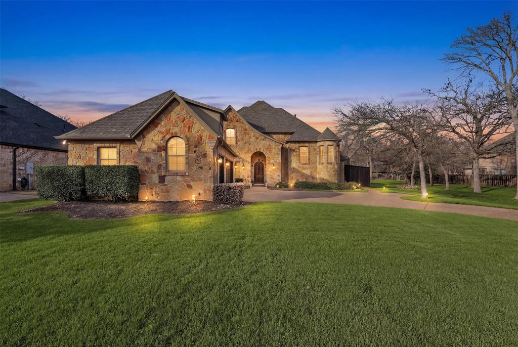 Welcome to this stunning custom home nestled on a quiet street in Arlington. From the moment you arrive, the impressive stone exterior, grand arched entryway, and spacious three-car garage create a striking first impression. Step inside to a dramatic foyer featuring a sweeping staircase, elegant tile flooring, and soaring ceilings that set the tone for the craftsmanship found throughout the home.

The spacious living area boasts towering ceilings, rich wood trim, a beautiful stone fireplace, and large windows that fill the space with natural light. The open layout flows seamlessly into the kitchen, where you'll find granite countertops, custom wood cabinetry, a center island, stainless steel appliances, and plenty of space for cooking and entertaining.

The primary suite offers a peaceful retreat with tray ceilings, a spacious layout, and a luxurious ensuite bathroom featuring dual vanities, a soaking tub, a large walk-in shower, and an oversized walk-in closet. Additional bedrooms are generously sized and provide comfort and flexibility for family or guests.

Step outside to your own backyard oasis complete with a large covered patio, outdoor living space with ceiling fans, and a beautiful resort-style pool with a natural stone waterfall feature—perfect for relaxing or hosting gatherings year-round.

With timeless architectural details, quality finishes, and exceptional indoor-outdoor living spaces, this home offers the perfect blend of elegance and comfort in a desirable Arlington location. Schedule your private showing today!