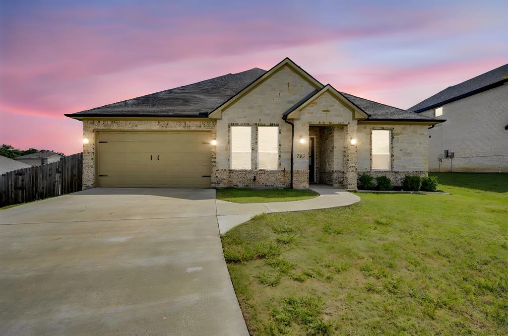 Beautiful 2021 single-story home tucked away on a quiet cul-de-sac in desirable Sleepy Hollow Manor! This spacious 4-bedroom, 3.5-bath home offers 2,910 square feet with an open floor plan, luxury vinyl plank flooring, vaulted ceilings, decorative lighting, and a warm, inviting living area with fireplace. The kitchen is a standout with granite countertops, large island, eat-in dining space, walk-in pantry, built-in cabinetry, and plenty of storage. The private primary suite features dual sinks, separate vanities, oversized shower, and a generous walk-in closet. Secondary bedrooms are nicely sized, including one with an ensuite bath, plus a dedicated office, mud room, and oversized 2-car garage. Sitting on over a third of an acre, the large backyard offers a sprinkler system, covered patio, private yard, and plenty of room to relax, play, or entertain. No HOA and conveniently located near schools, shopping, and easy access to Ennis amenities!New gutters and a 4x6 storm shelter in garage installed in 2024.