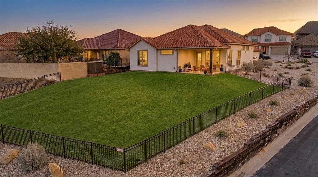 Stunning Spanish-style home located in the highly sought-after Tuscan Village subdivision in Glen Rose. From the moment you step inside, you’ll be captivated by the soaring 12-foot ceilings accented with wood beams and an open-concept layout that seamlessly connects the living, dining, and kitchen areas. Abundant windows fill the space with natural light. The chef’s kitchen is a showstopper, featuring granite countertops, an oversized island, double ovens, and a spacious butler’s pantry offering exceptional storage. The living area is anchored by a striking stone fireplace with a low-maintenance electric insert. The primary suite is a true retreat with vaulted ceilings and a spa-like ensuite bath complete with a soaking tub, separate vanities, a walk-in shower, and an impressive 160-square-foot walk-in closet. A versatile flex room just off the main living area is perfect for a home office, media room, or creative space. Two additional bedrooms and a full bath are thoughtfully positioned in a separate wing, providing privacy for guests or family members. The oversized utility room offers abundant cabinetry, storage, and convenient mud space. Enjoy outdoor living on the covered back patio overlooking scenic Hill Country views and a large, fenced backyard with a sprinkler system—perfect for relaxing, entertaining, or play. Additional highlights include spray-foam insulation for excellent energy efficiency, clay tile roof, and access to outstanding neighborhood amenities, including a community pool, clubhouse, fishing pond, and walking trails. Located within the highly acclaimed Glen Rose ISD, making this home an exceptional opportunity for comfort, style, and lifestyle living.