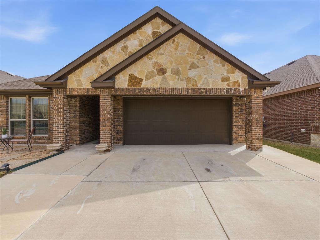DON'T MISS A $5000 BUYER INCENTIVE WITH USE OF HOMESPIRE HOME LOANS. SEE LISTING AGENT FOR DETAILS AND SEE FLYER IN TRANSACTION DESK. Beautiful, warm & cozy from the start! This home greets you and makes you want to see more! You walk into this gorgeous home through an ornate wood, iron and glass front door and once you enter the home there is a custom accent wall, arched doorways and an open floor-plan. This welcoming home has 3 bedrooms and 2 full bathrooms with a large family room that flows into the eat-in kitchen with granite counter tops, walk-in pantry, SS appliances, induction range, and an added kitchen island with a marble top which will stay with the home. Beautiful luxury laminated flooring in the main areas, tall ceilings and ceiling fans in all rooms. The primary bedroom is spacious with a walk-in closet that has a custom closet system from The Container Store. The utility room fits a full size washer & dryer and has shelving to store all needed essentials. The washer & dryer and the smart google nest doorbell will stay with the home. The backyard has a covered patio with a large extended concrete patio which is perfect for family events and entertaining. This home is not in an HOA and close to major highways, Waxahachie Sports Complex, restaurants and more. There is still 3 years left on the Builder 10year warranty with RWC, warranty brochure available. YOUR DREAM HOME AWAITS!