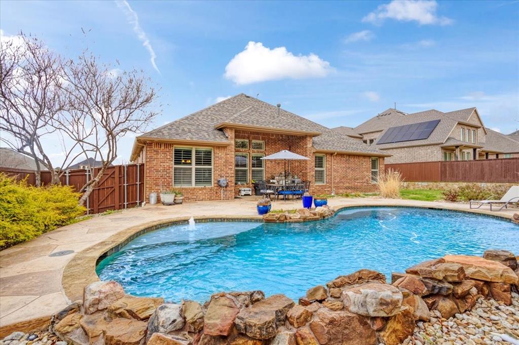 Welcome to this stunning North facing 4 bedroom 3 bath home in the upscale Wildwood Estates of Prosper. Experience elevated living at 660 Lockton Lane, an exceptional residence in the prestigious community of Prosper. Thoughtfully designed and impeccably maintained, this home blends timeless elegance with modern sophistication, offering a lifestyle defined by comfort and luxury. No MUD or PID!!

From the moment you enter, you’re greeted by expansive living spaces, soaring ceilings, and an abundance of natural light that highlights the home’s high-end finishes and architectural detail. The open-concept design creates a seamless flow, perfect for both intimate gatherings and grand entertaining.

At the heart of the home, the gourmet kitchen impresses with premium appliances, custom cabinetry, and an oversized island, all overlooking a stunning living area designed for effortless entertaining. Every space has been curated with both style and functionality in mind.

The private owner’s suite is a true sanctuary, featuring a spa-inspired bath, separate shower, generous proportions, and a tranquil ambiance that invites relaxation. Spacious secondary bedrooms, an office, and flexible living areas provide comfort and versatility for family and guests alike.

Step outside to your own resort-style backyard, where a sparkling pool and beautifully designed outdoor living space create the ultimate setting for entertaining or unwinding. Whether hosting summer gatherings or enjoying quiet evenings under the stars, this outdoor retreat elevates everyday living.

Ideally located near top-rated schools, upscale dining, and premier shopping, this home offers the perfect blend of privacy, convenience, and sophistication.
