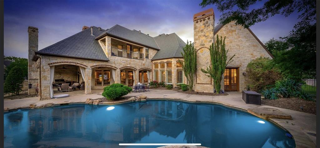 Situated on 1+ acre, this stunning home features 5 ensuite bedrooms, 2 half baths, gameroom, media room, Xtra large wine cellar, 2 offices and two oversized garages. The resort-worthy outdoor oasis has a saltwater pool, hot tub, and a spacious outdoor living area with a fireplace, dining area, and built-in grill. The master retreat offers space to relax & a spa-like bath with dual vanities & 2 walk-in closets. BOTH offices feature built-ins & fireplaces. Gameroom with wet bar and balcony overlooking the park-like backyard. Soaring ceilings, open floor plan, exquisite millwork and custom built-ins throughout. Work from home in 1 of 2 offices. The gourmet kitchen features double ovens, oversized center island, pot filler, veggie sink in island, walk-in pantry, and tons of prep space. This home is the perfect environment for relaxing & entertaining! Owner is a licensed real estate agent.