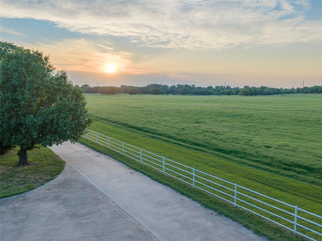 Rarely does a ranch of this caliber come to market. This 192± acre legacy property in Rhome (Wise County) is one of the most compelling ranch opportunities in the region. Approx. 75 acres of improved hay pasture consistently yield over 500 large round bales annually. Balance of ranch supports a proven 60-head cattle operation with a strong history of Red Angus production. Improvements include a comfortable ranch house, large hay shed, functional barn, and well-equipped shop — operational from day one. Nearly 2 miles of West Fork Trinity River frontage winds through mature timber offering excellent whitetail, turkey, and hog hunting plus outstanding fishing. Situated squarely in the path of DFW Metroplex's northward expansion into Wise County — significant investment upside for a legacy asset with this level of water, infrastructure, and productivity. Whether continuing the ranching tradition, holding an appreciating asset, or positioning for future development — the opportunity is as versatile as it is rare. Contact listing agent for private showing.