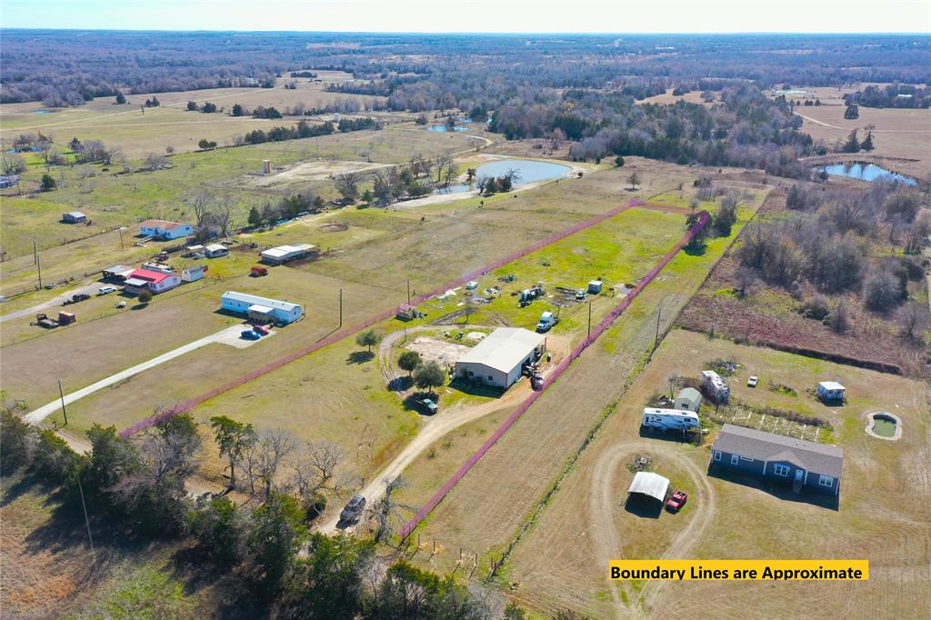 Turn the shop into a Barndo or bring in your mobile home.  Water, electric, and septic in place.  Approx 3 acres with 40 x 50 insulated shop with 25 x 40 carport, water and electric, two exterior doors, one large roll up door, three windows.  10 x 14 greenhouse, 6 water faucets outside, chicken coop,      
10 x 12 pole barn, perimeter fenced and gated entrance. No deed restrictions.