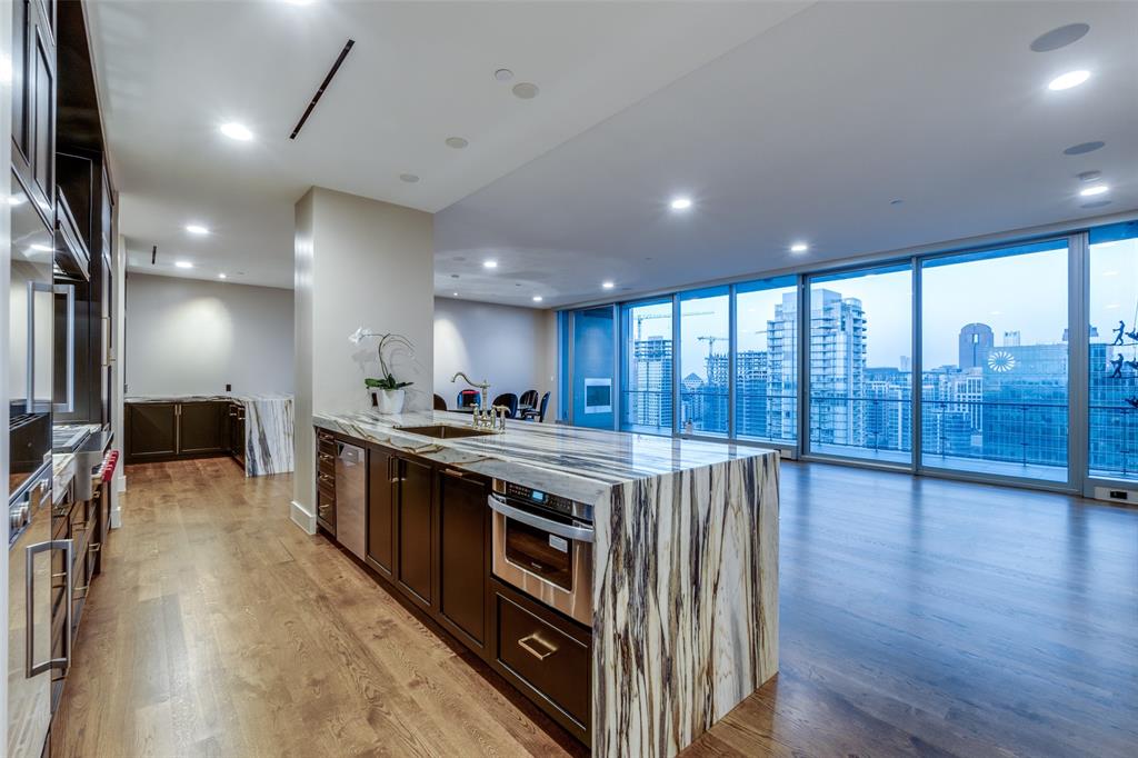 Exceptional opportunity to own at Bleu Ciel, located in the heart of Harwood District. Be mesmerized by the jaw
dropping views of Downtown that frame this custom, designer finished 3 bedroom home with oversized balcony, power
shades, mud room, den, wet bar, 2 fireplaces & private 4 car garage. The owner's suite offers a marble clad bath w
soaking tub, dual sinks, separate shower & large custom closet. The gourmet kitchen showcases Miele appliances,
Quartz countertops, a six burner gas cooktop, built-in microwave, dual sinks, ample storage + wet bar w ice maker