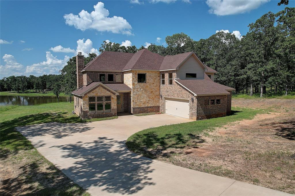 Luxury Lakeside Living at The Bluffs on Cedar Creek Lake

Discover timeless Texas charm in this brand-new, beautifully designed 4-bedroom, 4-bath home offering nearly 3,000 square feet of elegant living space. Located in the exclusive Bluffs at Cedar Creek Lake, this two-story residence combines classic style with modern comfort, creating the perfect retreat for everyday living and weekend getaways.

Step inside to find an open, light-filled layout with two expansive living areas, a private home office, and a chef-inspired kitchen complete with a walk-in pantry and a separate butler’s pantry—ideal for entertaining and everyday convenience. Upstairs, each of the three secondary bedrooms includes a private en-suite bath, providing comfort and privacy for family and guests.

The oversized 2-car garage offers ample room for vehicles, lake toys, and storage. With high-quality finishes and attention to detail throughout, this home is built to last and designed to impress.

Set on a peaceful interior lot facing Lake Andrew, you’ll enjoy quiet mornings, scenic views, and visits from local deer right from your front porch. Just a short stroll away, the neighborhood’s private marina and clubhouse await—offering lake access, boat slips, and a welcoming community atmosphere.

Don’t miss your chance to own a piece of lakeside paradise. Welcome to The Bluffs at Cedar Creek Lake—where refined living meets the beauty of nature.
