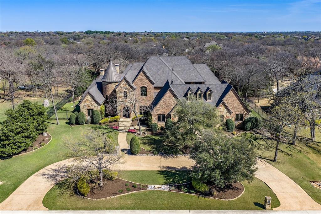 Set across two beautifully treed acres near Flower Mound and Highland Village, this exceptional Double Oak estate offers nearly 9,000 square feet designed for both everyday living and unforgettable entertaining. Thoughtfully planned with a rare multi-generational layout, the home features 7 bedrooms, 7 full baths, and 3 half baths, with every bedroom offering its own private ensuite for comfort and privacy.

The main living areas flow effortlessly and are filled with natural light, creating an inviting atmosphere throughout. A chef’s kitchen anchors the home with premium appliances, an oversized island, and an incredible walk-in pantry with custom built-ins designed for both function and storage. Multiple living and dining spaces provide flexibility for gatherings large or small, while a mudroom with built-in storage helps keep daily life organized.

A dedicated wine cellar provides the perfect space for wine enthusiasts and entertaining. Two private offices offer ideal work-from-home spaces, while an elevator allows convenient access between floors. The home also includes a dedicated workout area, dual laundry rooms for added convenience, and a spacious six-car garage offering extensive vehicle and storage capacity.

Upstairs, enjoy a true entertainment level featuring a private movie and media room along with a large game room complete with its own kitchen, making it perfect for hosting friends, celebrations, or extended family stays.

Step outside to your own backyard retreat. The expansive grounds offer privacy, mature trees, a saltwater pool and spa, generous patio space for entertaining, and a private putting green.


With an exceptional floor plan, luxury amenities, and the privacy of two acres near Flower Mound and Highland Village, this remarkable property blends space, comfort, and convenience in one extraordinary home.
