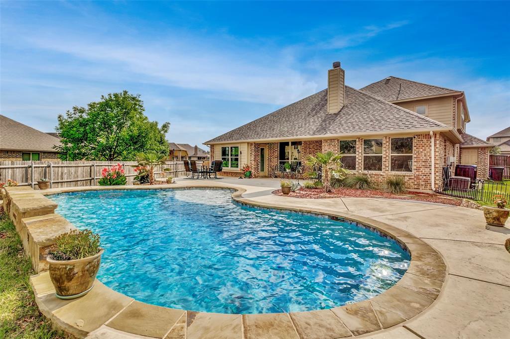 Stunning home situated on a premium lot, featuring a gorgeous heated saltwater pool just in time for summer. Designed with comfort and functionality in mind, this is the perfect floorplan, with multiple bedrooms  downstairs and a versatile upstairs retreat complete with a media room, flex space, and a private bedroom—ideal for guests, multigenerational living, or a teenager seeking extra privacy. The backyard is truly the showstopper, boasting an expansive patio, beautiful landscaping, and abundant green space rarely found in combination with a pool. Inside, the kitchen is a chef’s dream, equipped with a gas cooktop, generous counter space, and plenty of storage, making it perfect for both everyday living and entertaining. All of this plus a two and half car garage for extra storage. This home offers the perfect blend of indoor comfort and outdoor enjoyment. Schedule your private tour today, homes like this don't come along often.