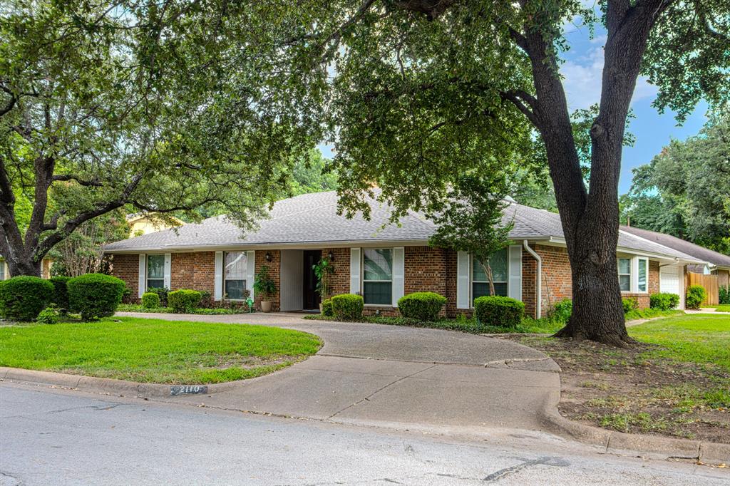 Nestled on a beautifully landscaped corner lot in the established Lakewood neighborhood, this spacious 4-bedroom, 3.5-bath residence offers over 2,500 square feet of thoughtfully designed living space. Rich hardwood flooring, vaulted ceilings, skylights, and an abundance of natural light create a warm and inviting atmosphere throughout. The updated kitchen features granite countertops, a gas range, ample cabinetry, and a convenient butler's pantry, making it ideal for both everyday living and entertaining. The expansive primary suite offers dual vanities, two walk-in closets, and a relaxing jetted tub. A private guest suite with its own bath provides flexibility for multigenerational living, visitors, or a home office. Enjoy year-round comfort in the bright sunroom overlooking mature trees and a beautifully maintained yard. Additional highlights include a circular driveway, side-entry garage, storage building, sprinkler system, and a prime location near schools, parks, shopping, and dining. A rare opportunity to own a well-maintained home with character, space, and versatility.