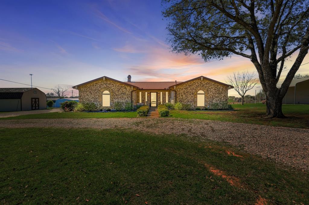 Here is your slice of Texas country just 30 minutes outside of downtown Fort Worth! This charming property has a 3 bedroom 2 bathroom home with a metal roof put on in 2016 sitting on a beautiful tract a bit under 2 acres with a fenced-in pasture and barn that has been used for livestock. Located in Cleburne ISD and close enough to shops and restaurants for country living with a side of convenience. Inside the home has a great split floor plan. The rustic stone fireplace comes with a gas starter and is perfect for those frosty nights. The countertops in the bathrooms and kitchen have been upgraded to a beautiful granite. Outside, enjoy the cool breeze and calming views from your back yard while you BBQ. The back driveway is covered with a large carport plus covered area for cooking or even a hot tub! A new aerobic septic system was installed in 2024, a tankless gas water heater was installed in 2020, and the HVAC system was replaced in 2023. With all the majors in great working order, this home comes with peace of mind. The wooden storage shed is in great condition and has a double barn loft for tons of storage. The metal workshop has a covered lean-to, perfect for parking a tractor or other vehicles and is wired with electricity and lighting inside. With easy access to the metroplex and room to breath, this home and its tranquil acreage is ready to be a part of the dream you're ready to build!