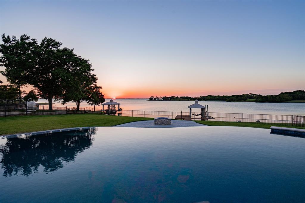 Absolutely stunning waterfront home with boat dock. This completely updated custom-built Rick Shipley home boasts beautiful lake views from almost every room and sits on over an acre lot. This home features generous living spaces with 5 bedrooms, a media room, a game room, a large loft area for an office, an additional room for a gym or kids' play area, a butler's pantry, plus much more. Home features include: all new flooring, all new bathrooms, resurfaced pool decking, new interior and exterior paint, updated can lights to LED, new outdoor kitchen, and all new landscaping. No detail has been left untouched making this a ture gem on the lake. The Owner's suite boasts gorgeous lake views and an attached room with an exterior door leading to your very own outside paradise. Whether you're seeking a serene retreat or a vibrant gathering spot, this lakefront home delivers it all. Don't miss out on the opportunity to own this remarkable property and enjoy the ultimate lakeside lifestyle!