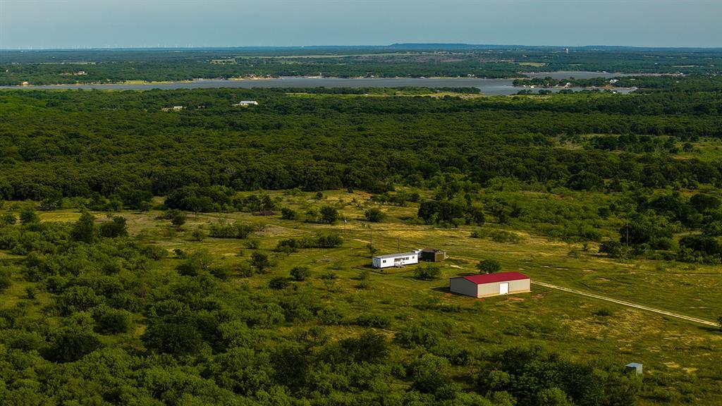 Located just northwest of Lake Nocona in Montague County, this versatile 80.3-acre property offers the perfect combination of ranching, recreation, hunting, and homesite potential. Built in 2023, the impressive 60' x 40' shop features dual roll-up doors and plenty of room for equipment, vehicles, storage, or a workshop. The property is fully fenced and cross-fenced with quality five-strand barbed wire fencing, complete with cattle guards for easy access throughout the ranch. Wildlife is abundant, with healthy populations of whitetail deer, turkey, dove, and hogs, making this an excellent hunting and recreational property. Two tanks provide water for livestock and wildlife while enhancing the natural beauty of the land. The ranch is well-equipped with two water wells, including a 15 GPM well and a 10 GPM solar-powered well. The solar well is conveniently located near an ideal homesite, offering a great opportunity to build your dream home with scenic views of the surrounding countryside. Whether you're looking for a productive cattle property, a hunting retreat, a weekend escape, or a place to put down roots, this ranch offers the space, infrastructure, and flexibility to bring your vision to life.